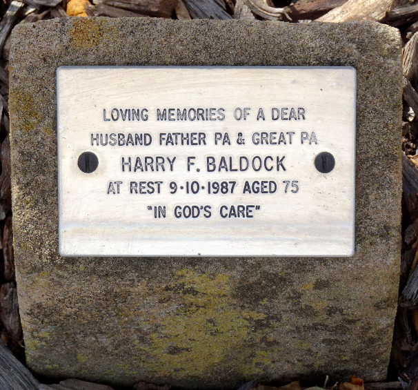 A memorial plaque reading "Loving memories of a dear husband father Pa & great Pa, Harry F. Baldock, at rest 9.10.1987 aged 75, In God's care."
