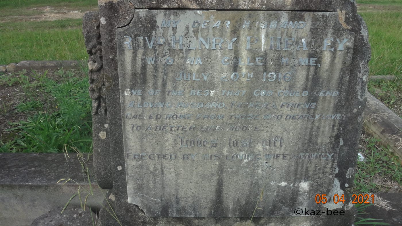 A weathered granite headstone plaque, inscribed to the Reverend Henry P. Healey, who died 20 July 1916.