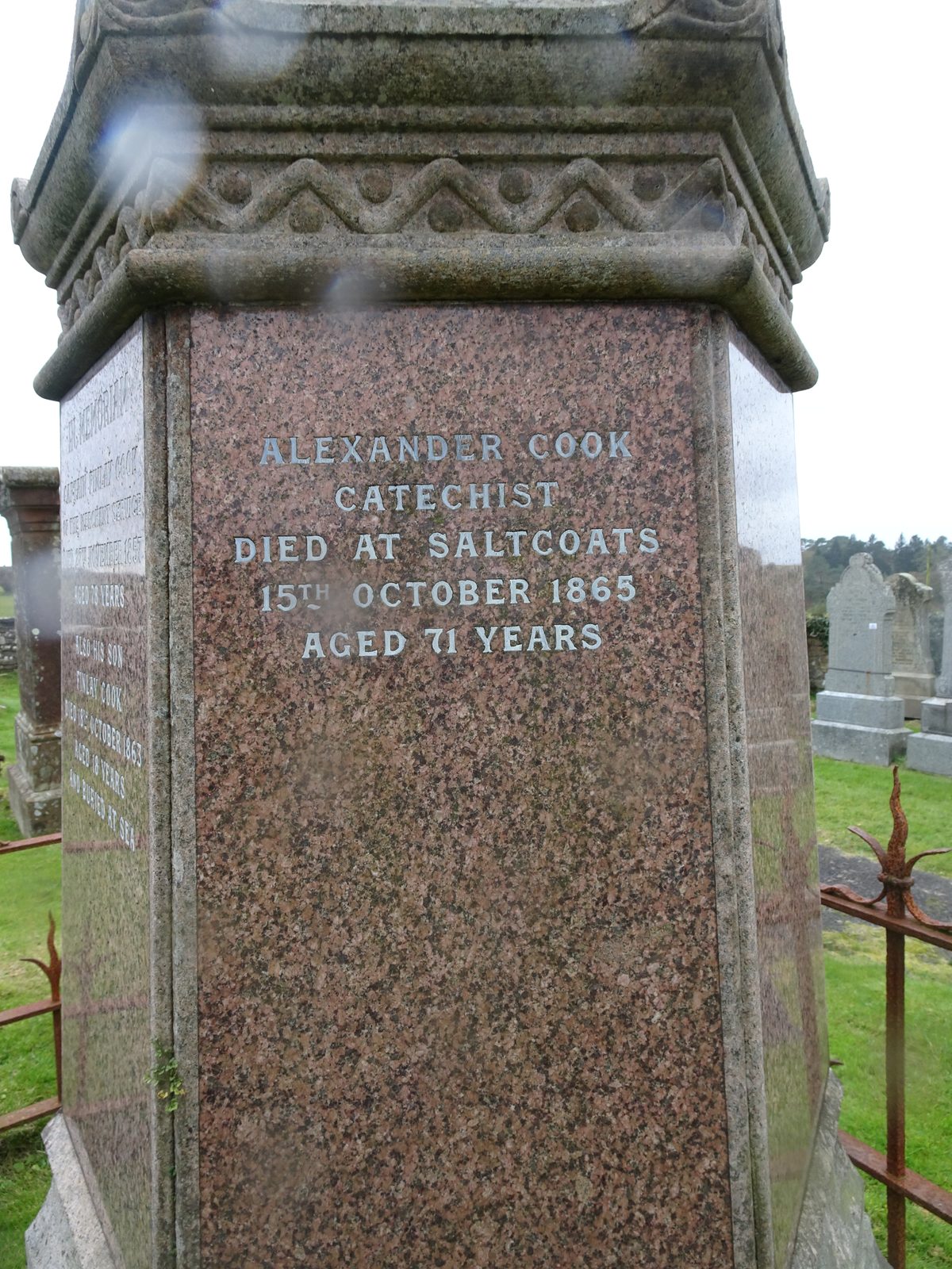 A polished granite pedestal with silvered lettering: Alexander Cook, catechist, died at Saltcoats, 15th October 1865, aged 71 years.