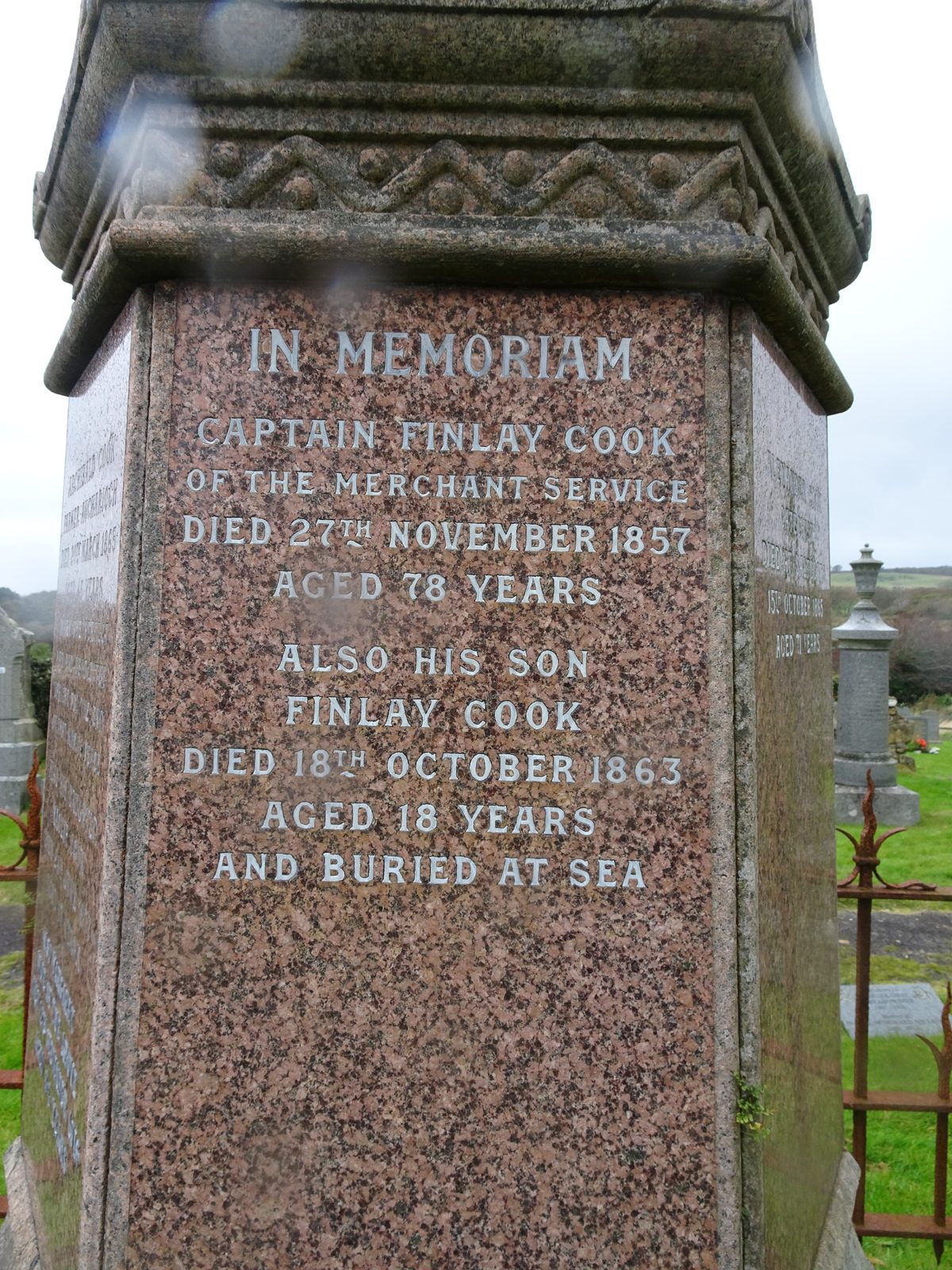 A polished granite pedestal with silvered lettering: In Memoriam, Captain Finlay Cook of the Merchant Service, died 27th November 1857 aged 78 years; also his son Finlay Cook, died 18th October 1863 aged 18 years and buried at sea.